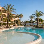 KI-generiertes Stimmungsbild einer palmengesäumten Poolanlage mit Kinderbereich für den Hipotels Said Hotelcheck in Cala Millor