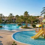 KI-generiertes Stimmungsbild einer Familienpoollandschaft mit Wasserspielbereich in Sa Coma für den Protur Safari Park Aparthotel Hotelcheck